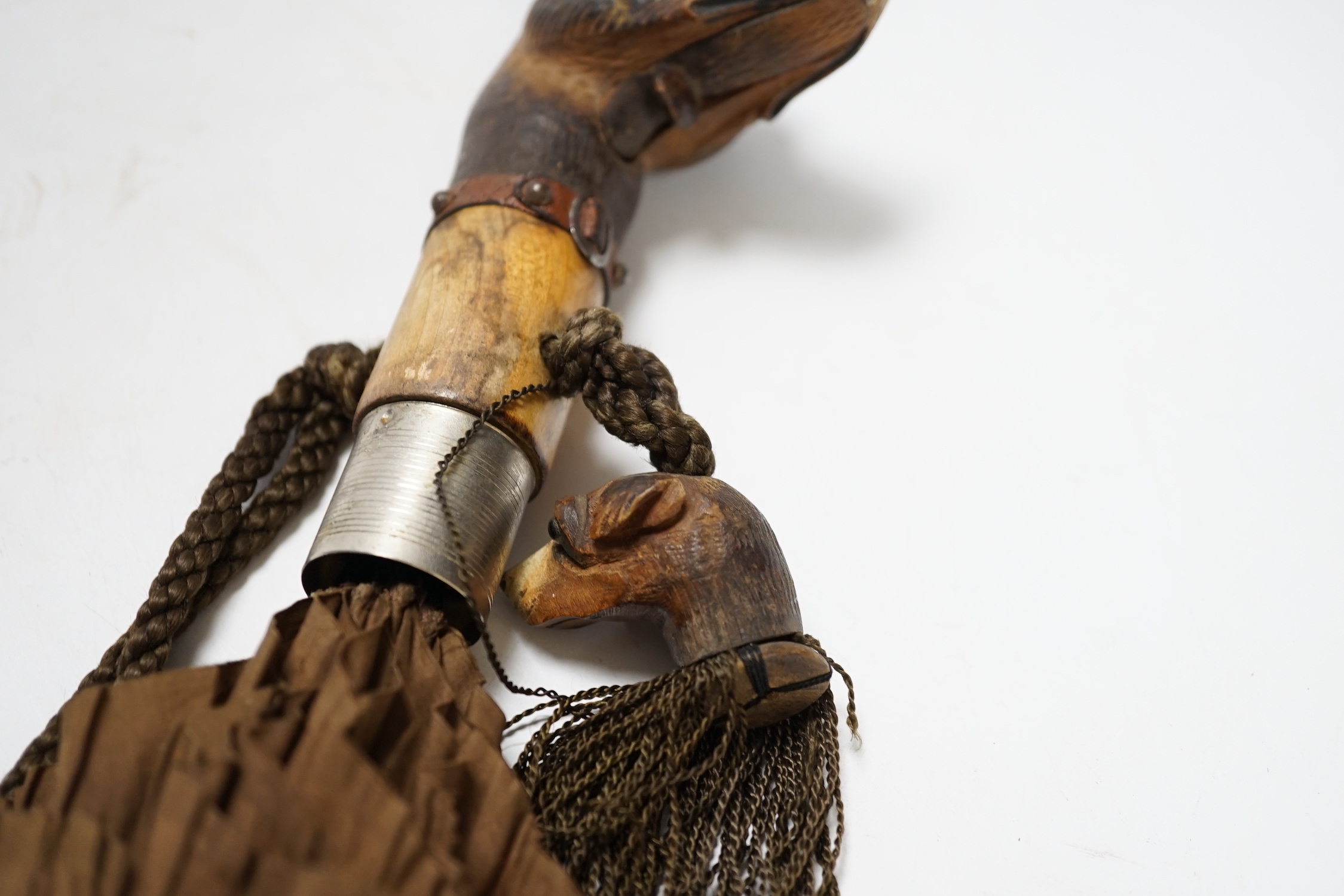 A Victorian silk parasol, carved ‘dogs head’ handle with articulated jaw and telescopic bamboo cover